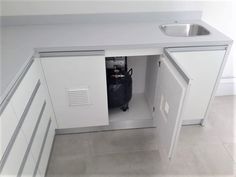 a small kitchen with a sink and an open cabinet