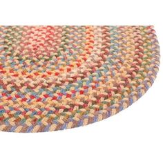 a multicolored round rug on a white background with an oval design in the middle