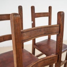 two wooden chairs sitting next to each other