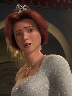 a woman with red hair wearing a tiara