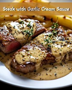 steak with garlic cream sauce on a white plate