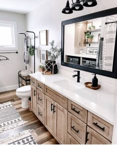 a bathroom with wooden cabinets and white counter tops