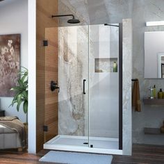 a bathroom scene with focus on the shower and bathtub in the foreground there is a rug on the floor