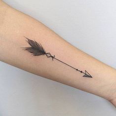 an arrow tattoo on the arm