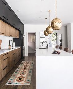 a kitchen with wooden floors and white walls