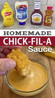 homemade chicken - fla sauce in a glass bowl with a hand dipping it into the dip