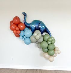 an elephant balloon sculpture hanging on the wall