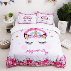 a white bed with pink flowers and unicorns on it