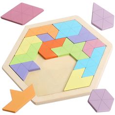 a wooden puzzle with four different colored pieces and an arrow pointing to the top one