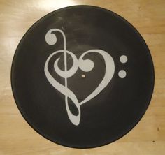 a black and white plate with a musical note in the shape of a heart