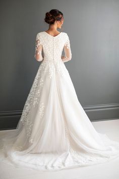 a woman in a wedding dress looking back