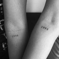 two people with matching tattoos on their arms, both have numbers tattooed on the arm