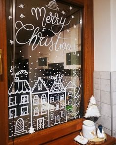 a christmas window with writing on it