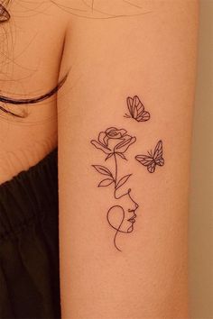 a woman's arm with flowers and butterflies on the left side of her body