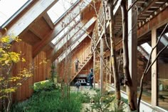 the inside of a building with wooden walls and stairs leading up to an upper level