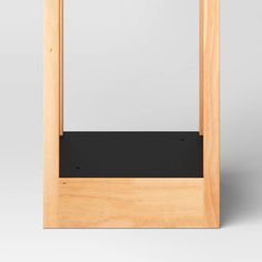 an empty wooden frame with black material on the top and bottom part, in front of a white background