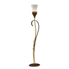 a floor lamp with a glass shade on it's arm and a metal base