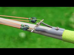 three wires connected to each other on top of a metal pole with green grass in the background