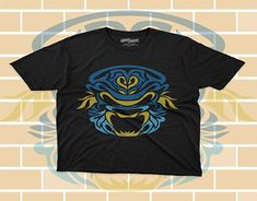 a black t - shirt with an image of a blue and yellow dragon on it