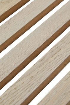 the slats of a wooden bench against a white background