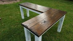 two wooden benches sitting on top of green grass