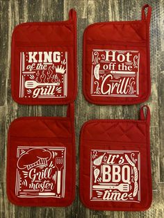 four red oven mitts with the words king of the grills and bbq time on them