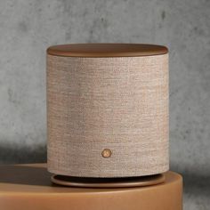 a tan speaker sitting on top of a table