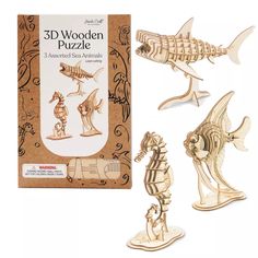 three wooden puzzles in front of a box with an image of fish and skeleton