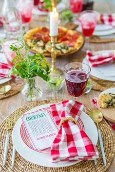 the table is set with plates, napkins and glasses