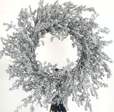 a wreath with scissors hanging from it