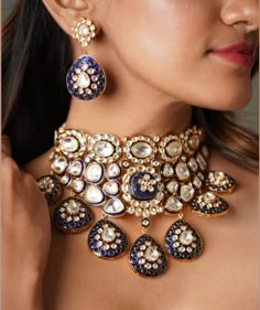 The majestically handcrafted kundan Bridal Wedding necklace set is an ode to the Indian tradition and intricate work handcrafted by the artisans. The bridal necklace embedded with high grade kundan and  hanging is a masterpiece inspired by Sabyasachi jewelry. The kundan earrings paired with the necklace are perfect for all the beautiful brides-to-be! Pair this replica of an ancestral jewelry necklace set with your traditional ensembles and create a look to remember. Necklace Closure - Adjustable Dori Earrings Closure - Push Back Style Tip - This pretty is made for a modern-day woman who has her heart in the little details of her traditional heritage. A perfect fit for a bride who is looking for a little whimsical charm and oodles of opulence with a hint of grandeur. Customized orders takes Luxury Chandbali Necklaces For Wedding, Luxury Traditional Kundan Necklace For Marriage, Luxury Meenakari Sets For Reception, Luxury Blue Kundan Necklace For Weddings, Blue Kundan Necklace With Intricate Design For Festive Occasions, Festive Blue Kundan Necklace With Intricate Design, Temple Jewelry With Motifs For Diwali, Festive Blue Kundan Necklace With Cutdana, Blue Chandbali Jewelry With Cutdana Detail