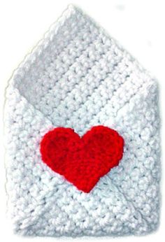 a white crocheted envelope with a red heart on the front and bottom flap