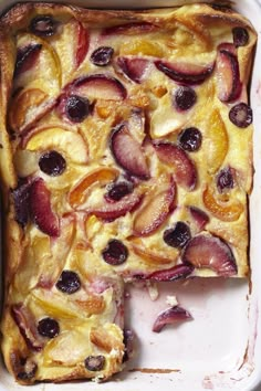 a close up of a cake in a pan with fruit toppings on the top