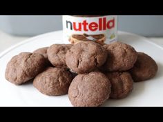 chocolate cookies on a plate next to a can of nutella