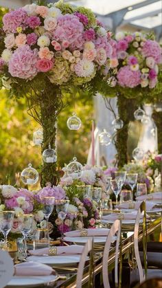 a table set up with pink and white flowers