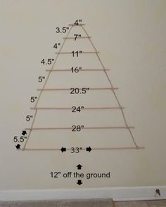 a christmas tree is shown with measurements for the top and bottom branches in front of it