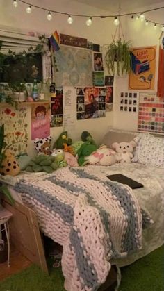 there is a bed with many stuffed animals on it in the room that has posters and pictures all over