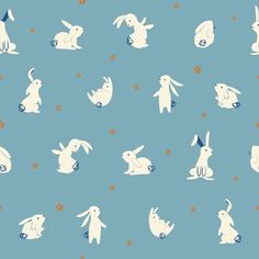 a blue background with white rabbits and flowers on it's sides, all in different sizes