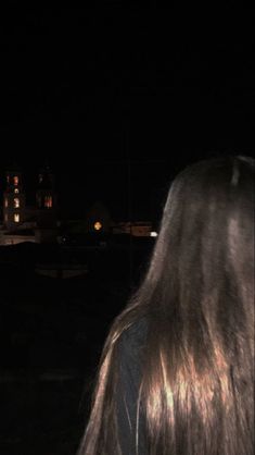 the back of a woman's head at night