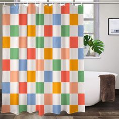 a bathroom with a bathtub, shower curtain and rugs in the shape of squares