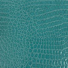 an alligator skin pattern in teal green, showing the crocodile's leather texture