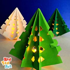 three paper christmas trees with lights on them