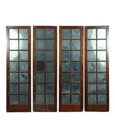 three wooden doors with glass panels on each side