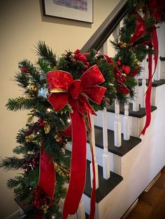 a christmas wreath is hanging on the banister