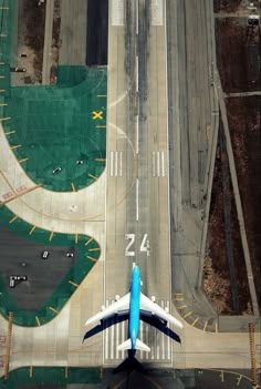 an airplane is flying over the airport runway and tarmacs as seen from above