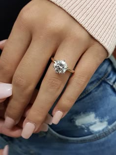 a woman's hand with a ring on it