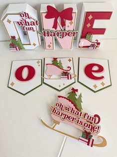 some paper cutouts are sitting on top of a white table with red and green decorations