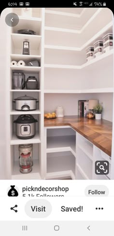 an image of a kitchen with white cabinets and shelves