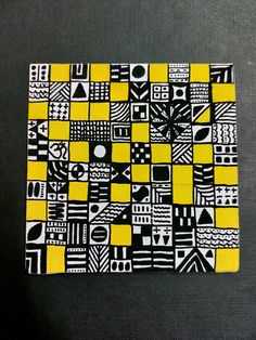 a yellow and black patchwork pattern on fabric