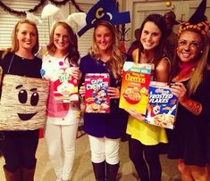 four girls in costumes holding up cereal boxes